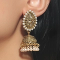 Vintage golden Jhumka bell earrings with white pearls and crystals worn by a model - Antique Gold