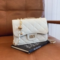 White quilted crossbody bag with gold chain strap and spherical metal ornament - White