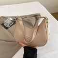 Beige crescent hobo bag with a silver metal bow accent and smooth leather finish - Khaki