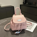 Pink mini retro backpack with top handle and drawstring closure on marble surface - Pink