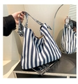 Detail of blue and white striped canvas tote with geometric woven shoulder strap - Blue