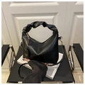 Detail view of black pleated crescent handbag with gold zipper and ruffles - Black