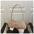 Close-up of beige underarm bag featuring a metallic silver bow buckle detail - Khaki