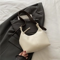 Minimalist beige hobo shoulder bag with a dark brown leather strap and smooth texture - White