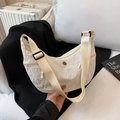 Minimalist off-white crescent crossbody bag in textured nylon with adjustable strap - White