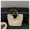 Chic beige crochet tote bag with brown leather straps displayed on a black leather bench - No Lining