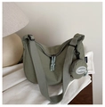 Detail of army green nylon crescent bag with wide strap and round coin purse attachment - Green