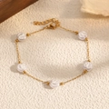 Detail of a gold stainless steel chain bracelet featuring five round white pearls - 5 Flat Round Pearls Style (STB2552-GO)