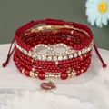 Gelaagde rode kralenarmband set met oneindigheidssymbool en gouden hart hanger - Rood