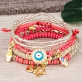 Bracelet multicouche bohème avec breloque œil porte-bonheur et main de Fatima sur bois - Rouge pastèque