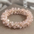 Elegant beaded hair tie with pale pink multifaceted crystals in a woven circular design - Pink