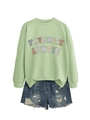 Detail of light green sweatshirt with Favorite Auntie text and distressed denim shorts - Olive Green