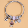 Silver beaded charm bracelet with fish and heart pendants on a soft orange background - Purple (15063101)