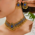 Ethnic peacock necklace set with blue gems and antique gold finish on model - Blue
