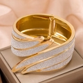 Elegant gold metal bangle with sparkling silver glitter feather design on pink silk - White