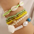 Macro detail of Bohemian multilayer bracelet set with starfish and seashell charms - Yellow (08090165)