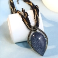Detailed shot of bohemian teardrop pendant with grey crackle stone and woven cord - Black