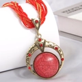 Bohemian style necklace with a large red marble stone pendant and beaded multi-strand cord - Red