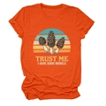 Detailed view of an orange cotton T-shirt featuring a retro sunset mushroom print graphic - S / Orange