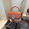 Brown leather and textured fabric crossbody bag with oval silver buckle detail - Brown