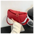 Close-up of red lychee grain leather handbag with decorative gold square buckle detail - Red