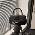 Elegant black handbag with woven texture and gold clasp for a retro luxury look - Black