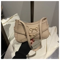 Detail of beige shoulder bag with golden butterfly buckle and decorative side straps - Khaki
