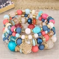 Détail de bracelets multicouches bohèmes avec perles colorées et un pendentif cœur arbre de vie - Rose Multicolore