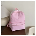 Minimalist pink student backpack with large capacity and mesh side pockets in a home setting - Pink