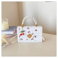Close-up of white cherry print bag with golden flower lock and rope handle - White