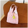 Detail of pink canvas tote featuring 3D floral embroidery and yellow flower charm - Pink with Pendant