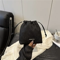 Minimalist black denim drawstring bucket bag with silver logo and handheld styling - Black