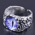 Macro detail of retro evil eye ring featuring a purple iris and aged metal texture - Purple