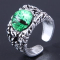 Macro detail of gothic evil eye ring with green stone and scaly texture - Green