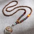 Ethnic style long wooden bead necklace with vintage round silver pendant and colorful stones - Brown