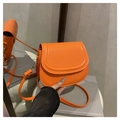Detailaufnahme der hellorangen PU-Leder-Satteltasche mit goldenen Haken und Ziernähten - Orange