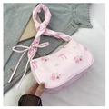 Close-up of pink floral shoulder bag with rose patterns, bow details and zipper closure - Pink