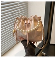 Detail of pink embroidered bucket bag with pearl handle and golden chain strap - Pink