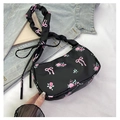 Close-up of black floral shoulder bag featuring pink bows, roses and ruffled strap detail - Black