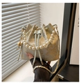 Macro detail of bucket bag showing golden floral embroidery and round pearl handle - Blue