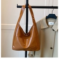 Detail of glossy brown oversized shoulder bag with large pocket and mirror-like finish - Brown