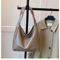 Detail of glossy khaki patent leather tote bag with reflective surface and sleek strap - Khaki