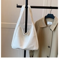Detail of white patent leather tote bag with glossy finish and front pocket for commute - White