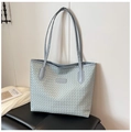 Detail of light blue-grey woven tote bag featuring long straps and fashion label - Blue
