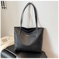 Close-up of a black woven faux leather tote bag with minimalist aesthetic and twin straps - Black