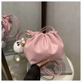 Detail of pink pleated bucket bag with plush monster charm and leather brand embossing - With Charm / Pink