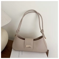 Detailed view of beige underarm bag featuring knotted shoulder strap and gold hardware - Khaki