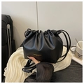 Close-up of black drawstring pleated bucket bag with gold logo and thin leather strap - No Pendant / Black