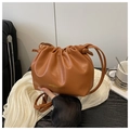 Detailed macro view of brown pleated cloud bucket bag with gold fashion text branding - No Pendant / Brown