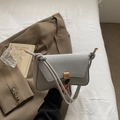 Bolso de hombro gris claro con solapa de textura mixta y broche metálico dorado - Plateado
